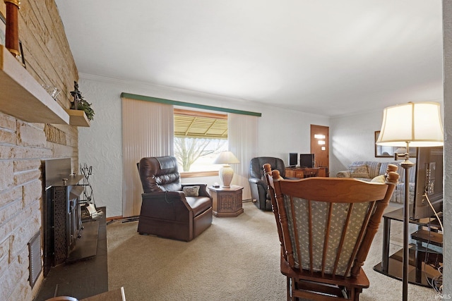 living room featuring carpet floors, a stone fireplace, and ornamental molding