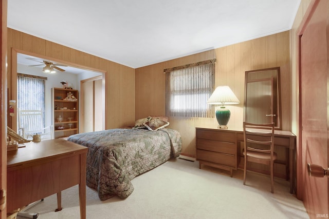 bedroom featuring multiple windows, carpet, and wooden walls