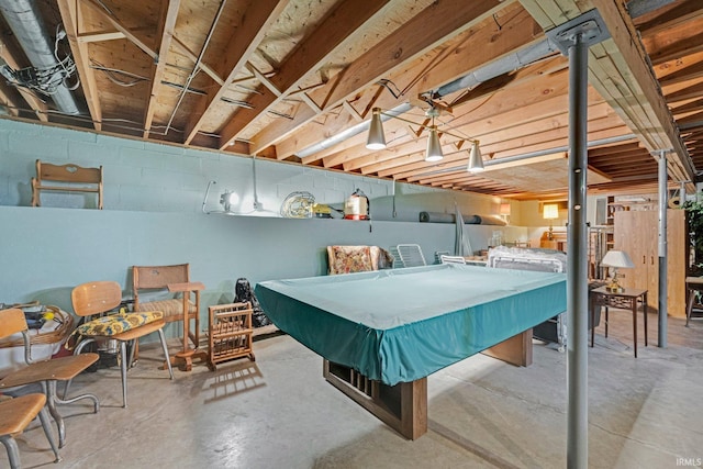 rec room with concrete block wall, pool table, and concrete flooring