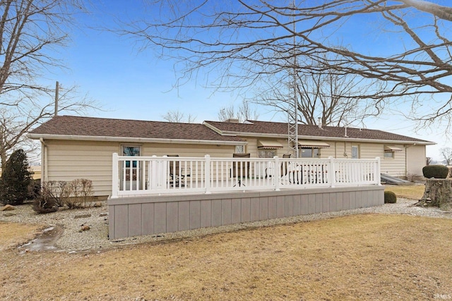 rear view of house with a deck and a shingled roof