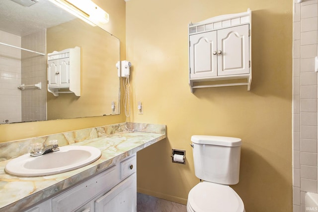 bathroom featuring vanity, toilet, and baseboards