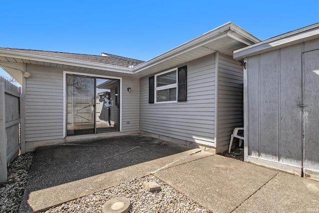 property entrance featuring a patio area and fence