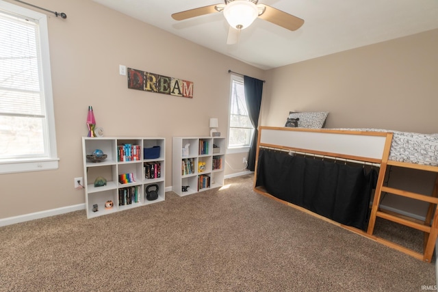 carpeted bedroom featuring a ceiling fan and baseboards