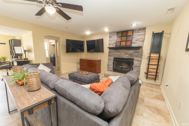 living room with visible vents, a fireplace, baseboards, and ceiling fan