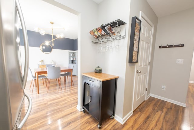 hallway with light wood-type flooring and baseboards