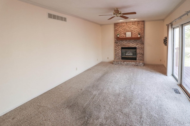 unfurnished living room featuring visible vents, carpet floors, a ceiling fan, and crown molding