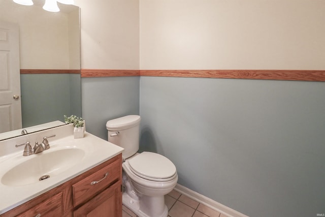 bathroom with tile patterned floors, toilet, vanity, and baseboards