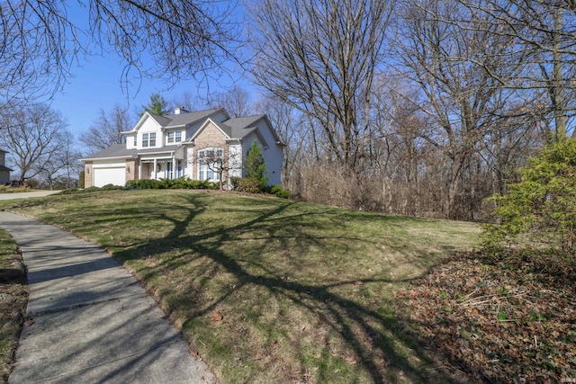 view of front facade with a front lawn and an attached garage