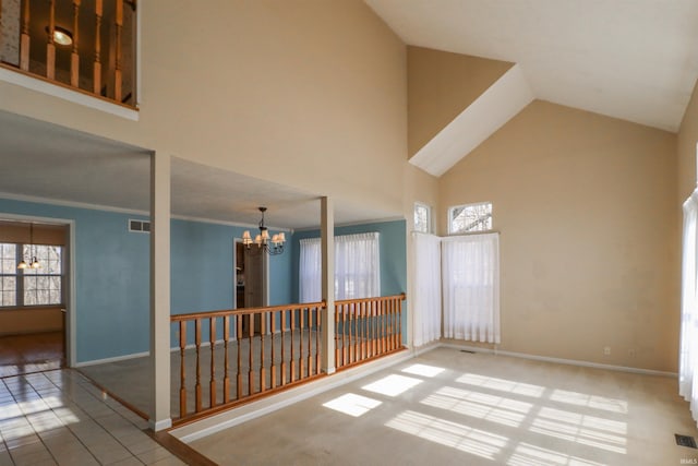 tiled empty room featuring a chandelier, visible vents, plenty of natural light, and high vaulted ceiling