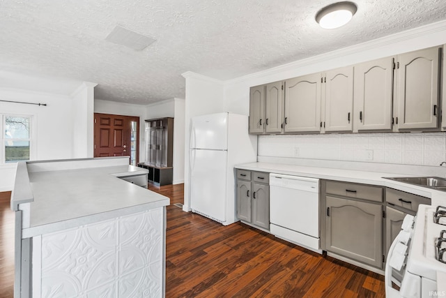 kitchen featuring decorative backsplash, white appliances, dark wood-type flooring, and gray cabinets