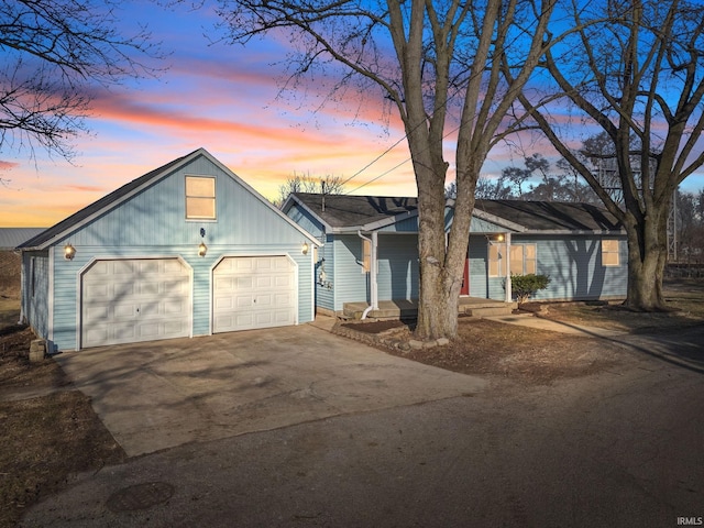 view of front of home featuring concrete driveway and an attached garage