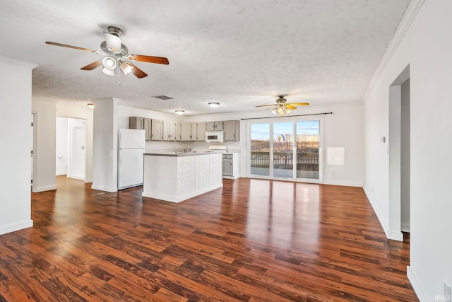 unfurnished living room with a ceiling fan, visible vents, dark wood-style flooring, ornamental molding, and a textured ceiling