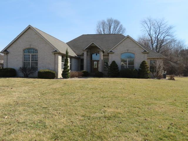 french country inspired facade featuring a front lawn