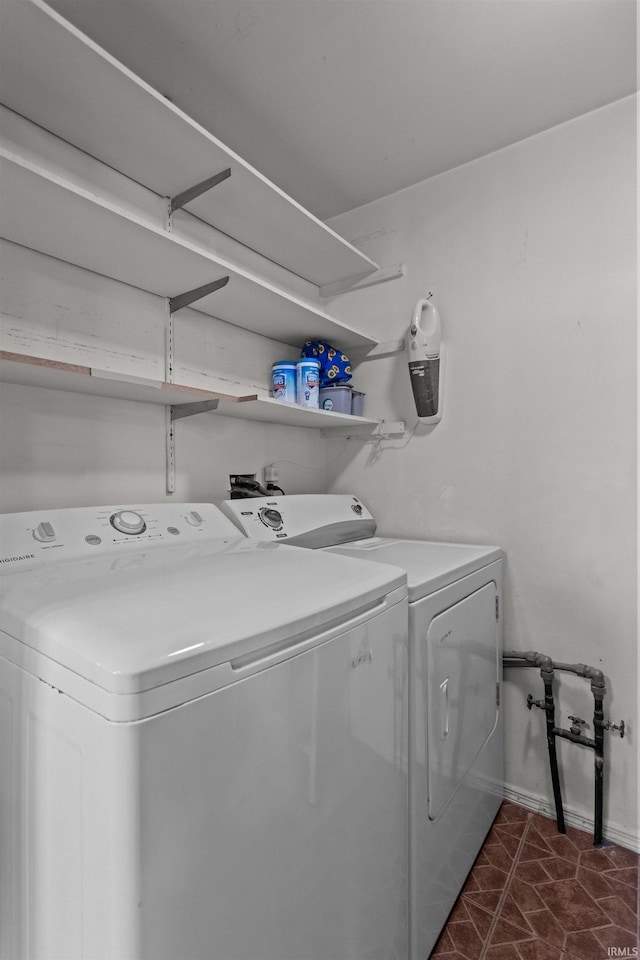 laundry room with washer and dryer, laundry area, and baseboards