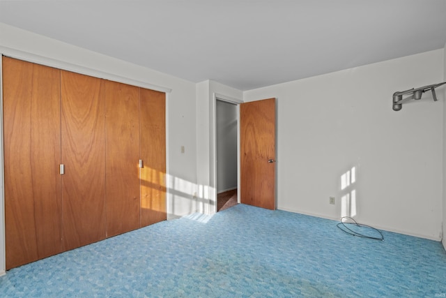 unfurnished bedroom featuring a closet and carpet