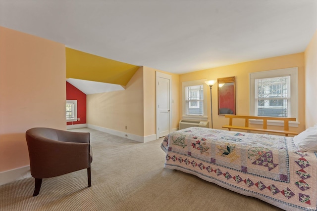 bedroom featuring carpet flooring, multiple windows, lofted ceiling, and baseboards