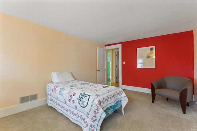 carpeted bedroom featuring visible vents and baseboards