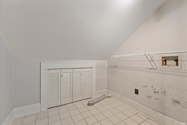 clothes washing area with light tile patterned floors, hookup for a washing machine, and laundry area