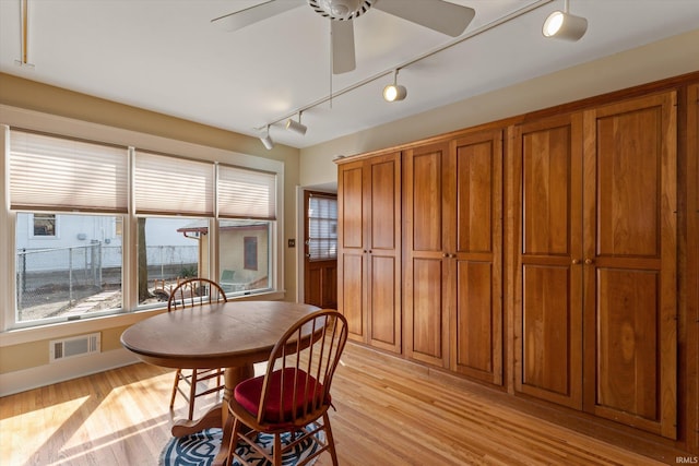 dining room featuring visible vents, ceiling fan, rail lighting, and light wood-style floors