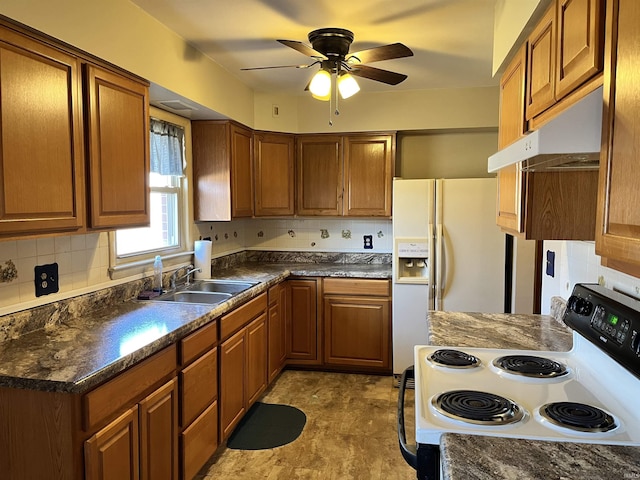 kitchen with dark countertops, decorative backsplash, electric range, a ceiling fan, and a sink