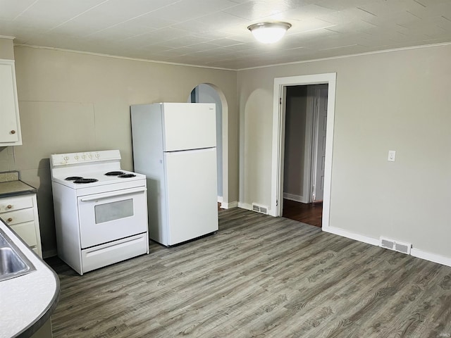 kitchen featuring white cabinetry, white appliances, wood finished floors, and visible vents