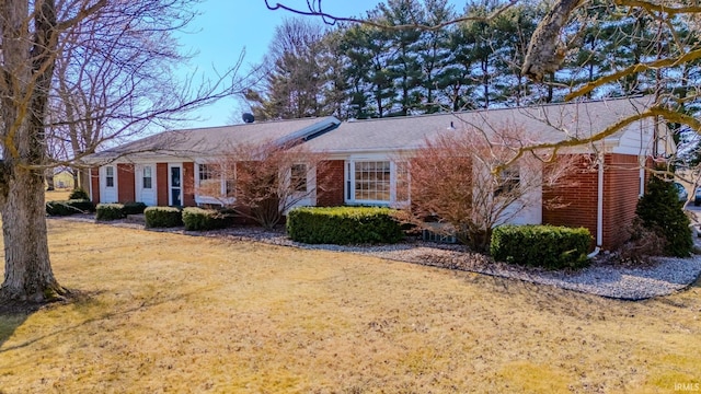 single story home with brick siding and a front yard