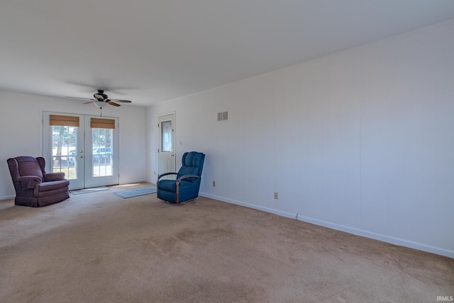 unfurnished room with french doors, carpet, visible vents, and ceiling fan