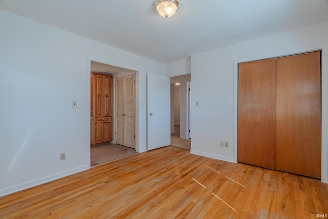 unfurnished bedroom featuring baseboards and wood finished floors