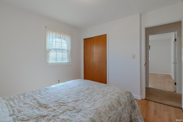 bedroom with a closet and wood finished floors