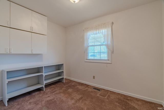 interior space with visible vents, baseboards, and carpet