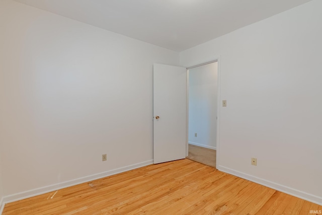 unfurnished room with light wood finished floors and baseboards