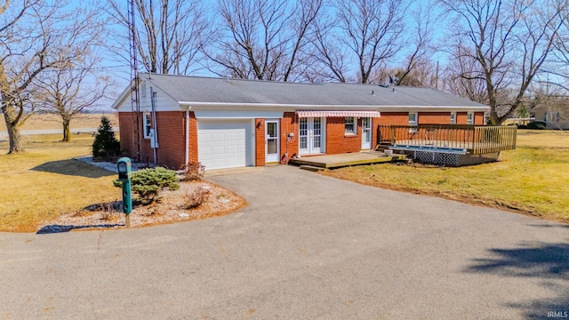 single story home featuring a front yard, an attached garage, a deck, aphalt driveway, and brick siding