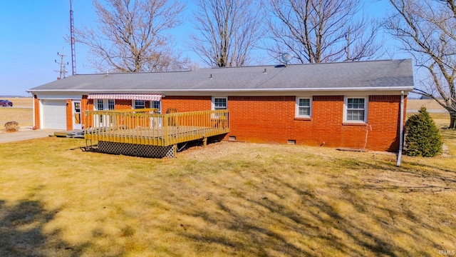 rear view of house featuring brick siding, a lawn, an attached garage, and a wooden deck