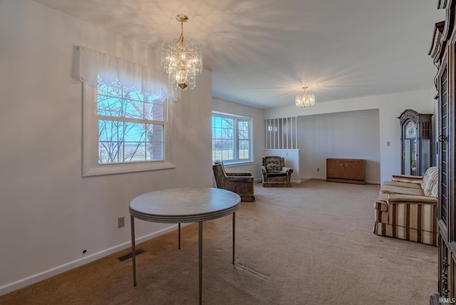 interior space featuring visible vents, baseboards, and an inviting chandelier