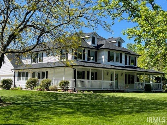 view of front of house with covered porch and a front yard