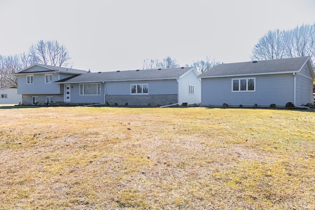 rear view of house featuring a lawn