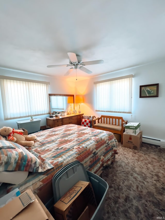 bedroom with a baseboard heating unit, carpet, and a ceiling fan