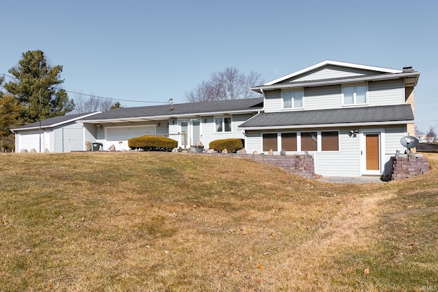 view of front of home with an attached garage and a front yard