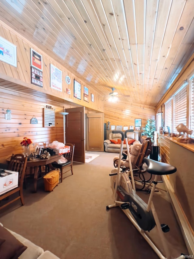 interior space featuring carpet floors, wooden walls, and wooden ceiling