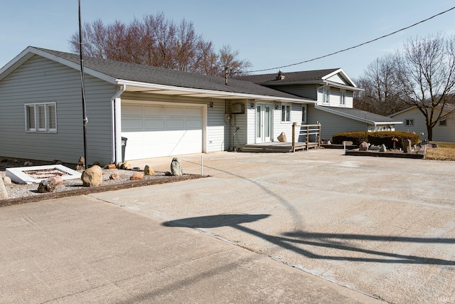 tri-level home with concrete driveway and an attached garage