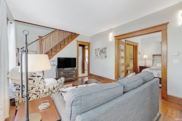 living area with stairs, wood finished floors, and baseboards