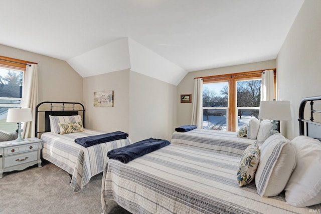 carpeted bedroom featuring lofted ceiling