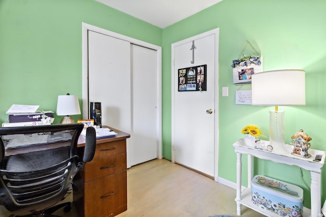 office area with light wood-style flooring and baseboards