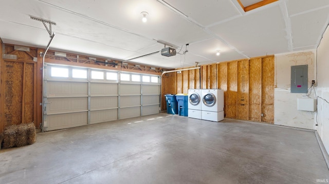 garage with electric panel, independent washer and dryer, and a garage door opener