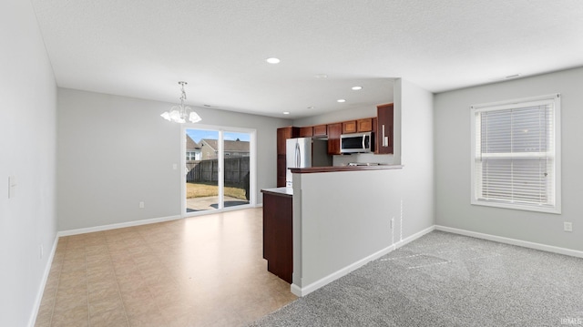 kitchen with recessed lighting, baseboards, a notable chandelier, and appliances with stainless steel finishes