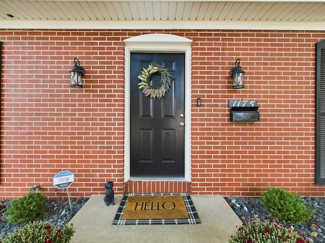 doorway to property with brick siding