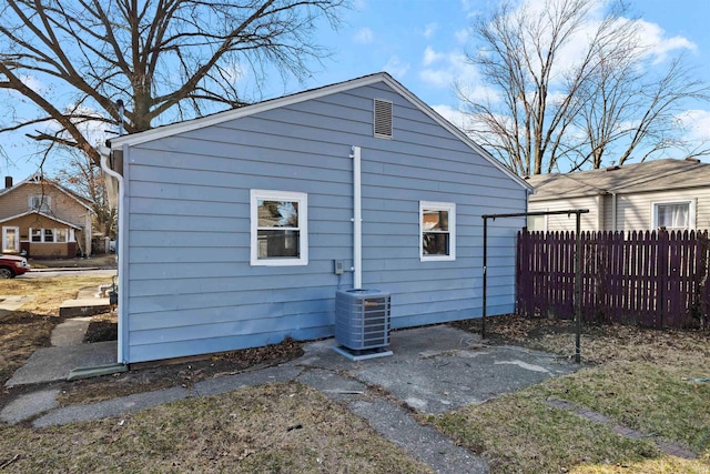 exterior space featuring central air condition unit and fence