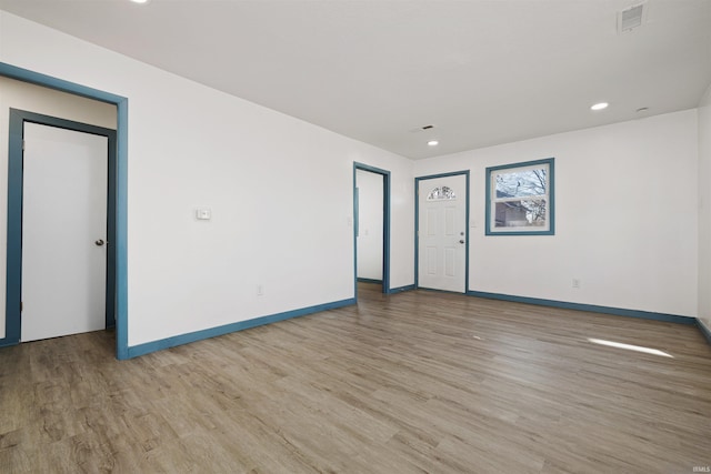 unfurnished room featuring recessed lighting, visible vents, baseboards, and wood finished floors