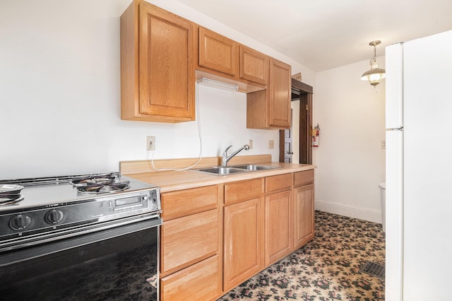 kitchen featuring a sink, black / electric stove, light countertops, and freestanding refrigerator