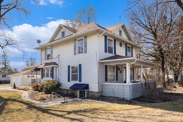 view of property exterior featuring covered porch, a yard, and fence